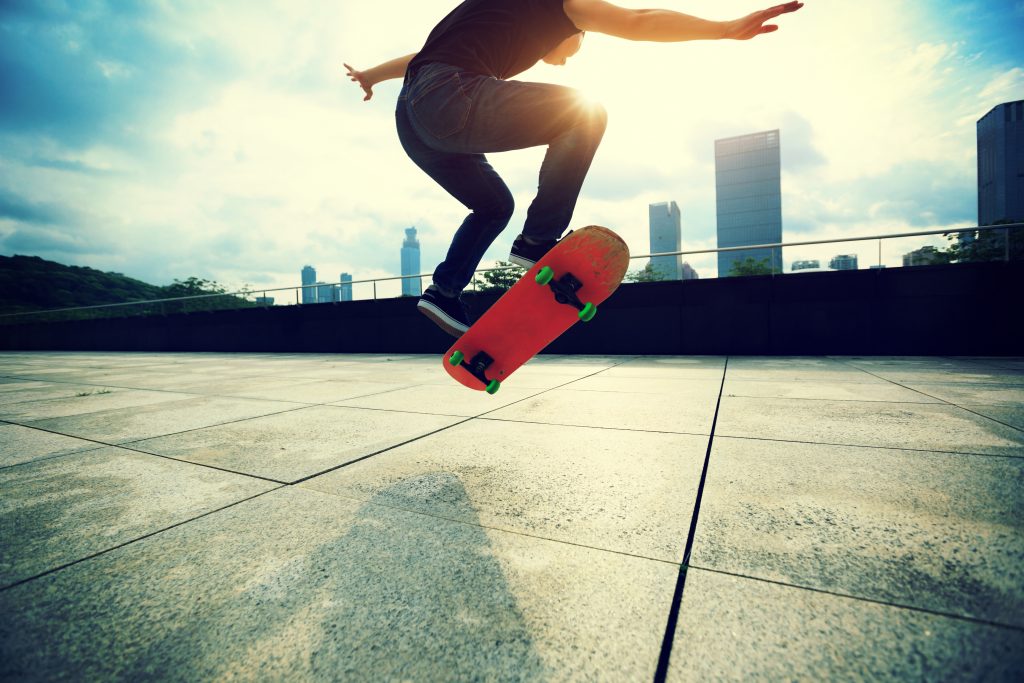 Young,Woman,Skateboarder,Skateboarding,At,City